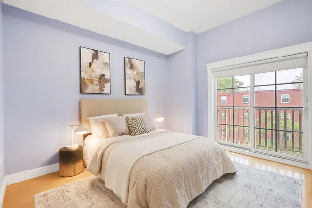 a bedroom with a bed and a large window