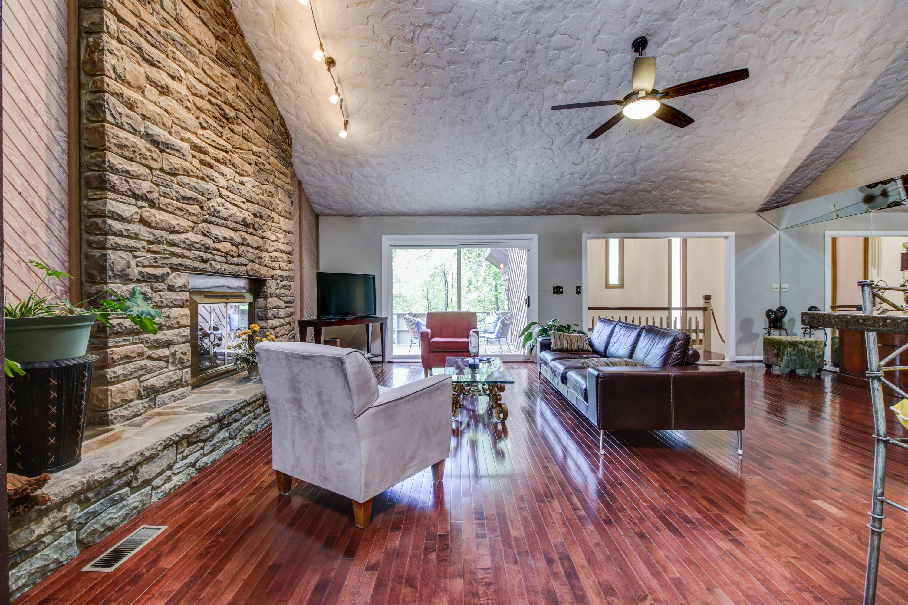 16 Stonehaven Lane Blue Ridge, VA 24064 - Photo 7 of 46 a living room with furniture a fireplace and a flat screen tv