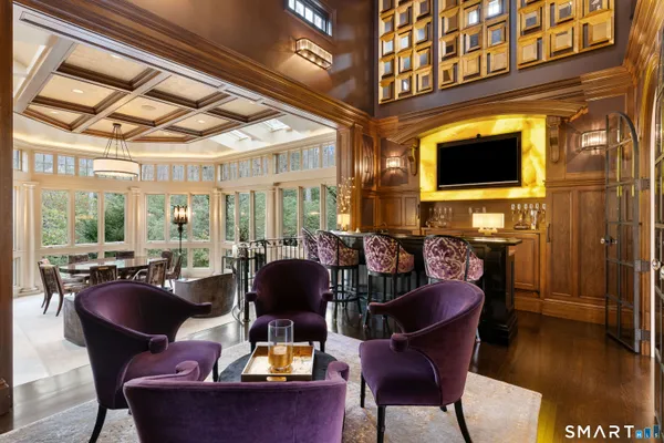a dining room with furniture a fireplace and wooden floor