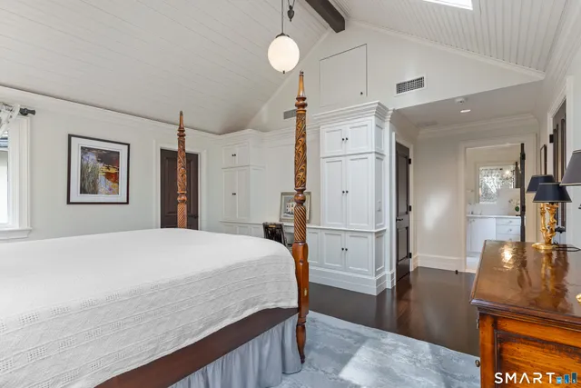 a large white bed in a white room