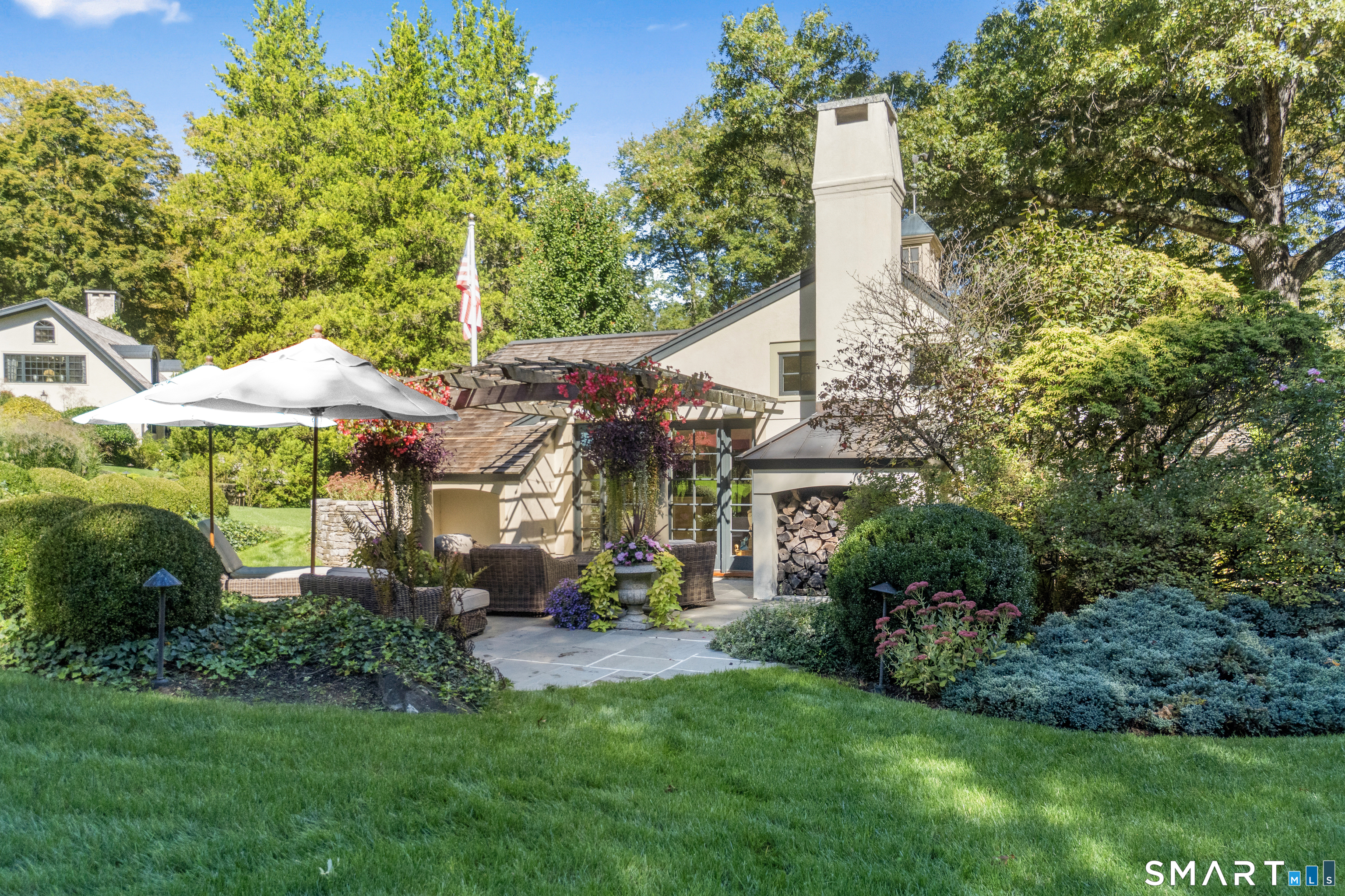 252 River Road Deep River, CT 06417 - Photo 23 of 40 a view of a house with a large windows and a yard with plants and large trees