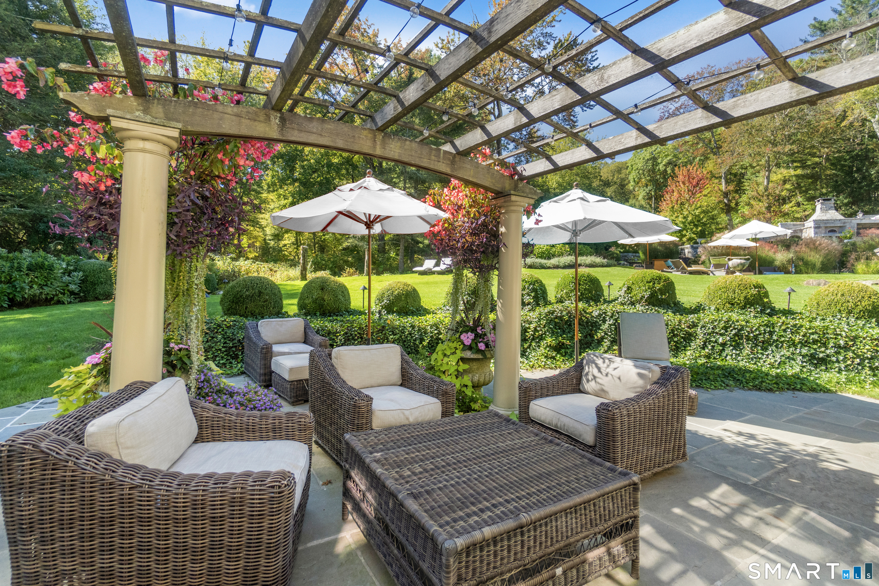 252 River Road Deep River, CT 06417 - Photo 26 of 40 a view of a patio with couches and table and chairs under an umbrella