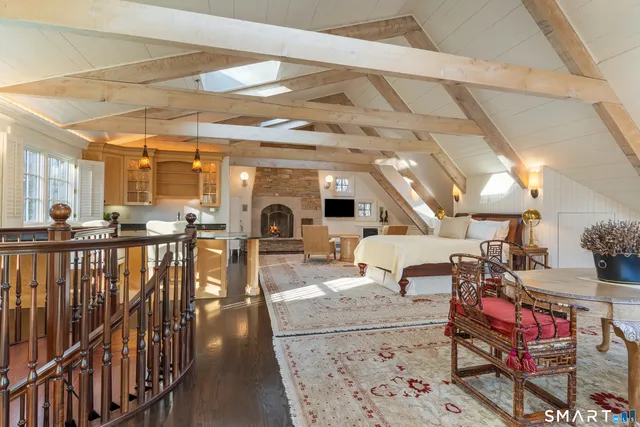 a living room with lots of furniture and a wooden floor
