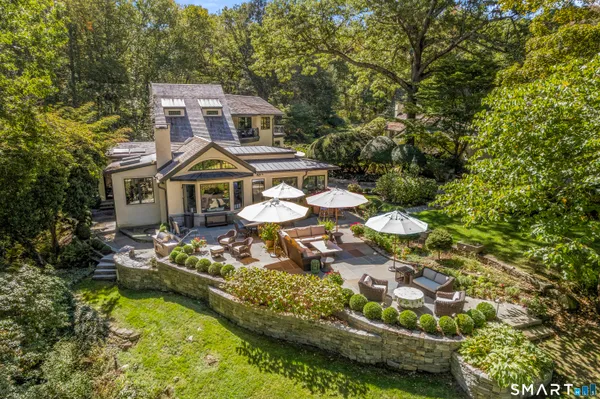 a front view of a house with swimming pool and yard