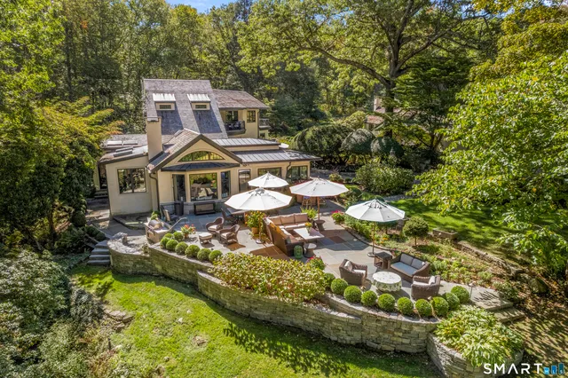 a front view of a house with swimming pool and yard