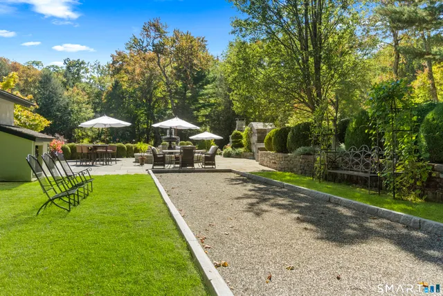 a view of yard with swimming pool and trees