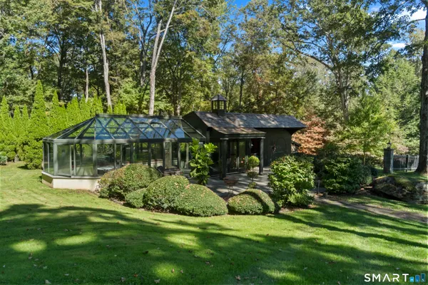 a view of a house with a backyard and a patio