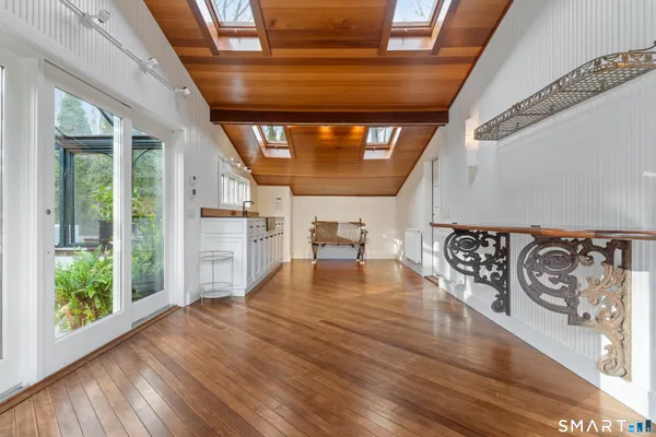 a view of an entryway with wooden floor