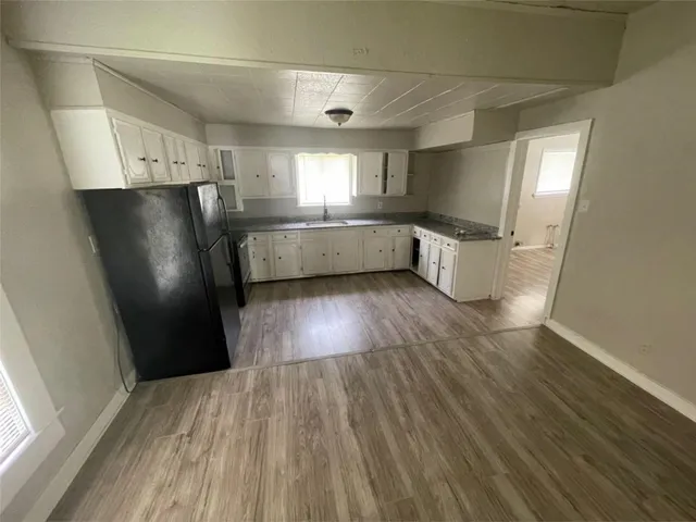 a view of a refrigerator in kitchen and wooden floor