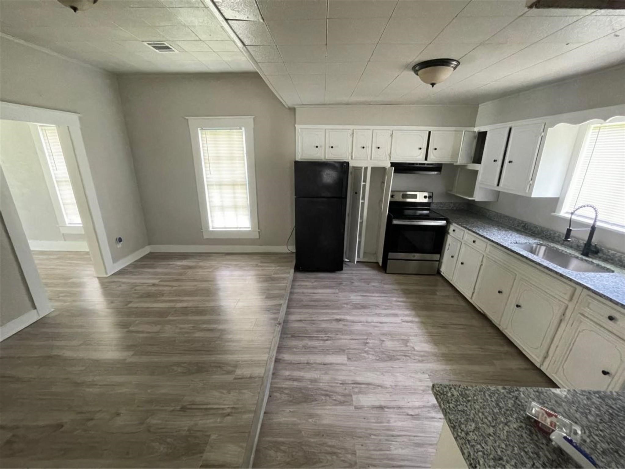 2010 13th Street Port Arthur, TX 77640 - Photo 13 of 22 a large bathroom with a glass door shower and a sink