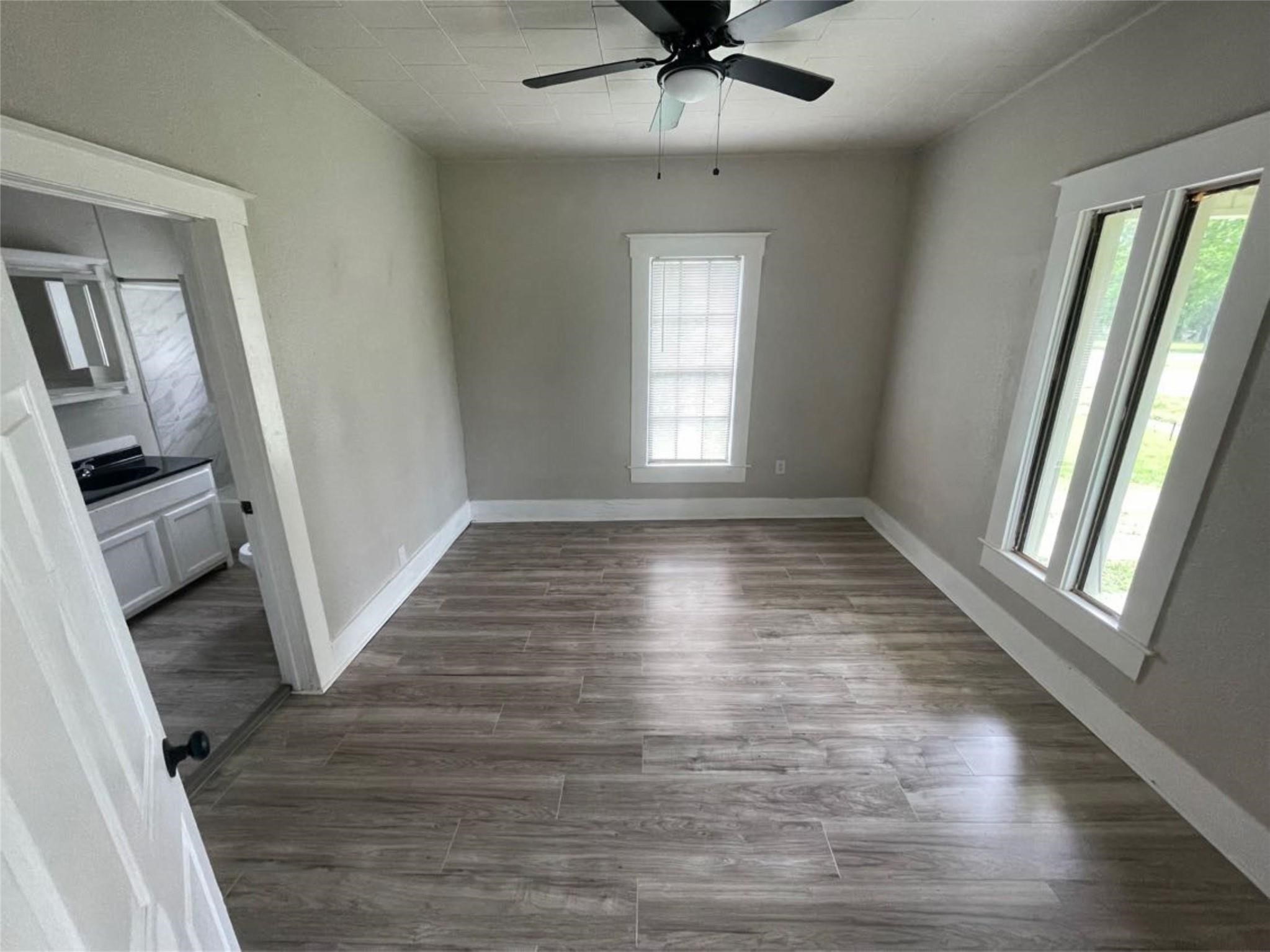 2010 13th Street Port Arthur, TX 77640 - Photo 15 of 22 wooden floor in an empty room with a window
