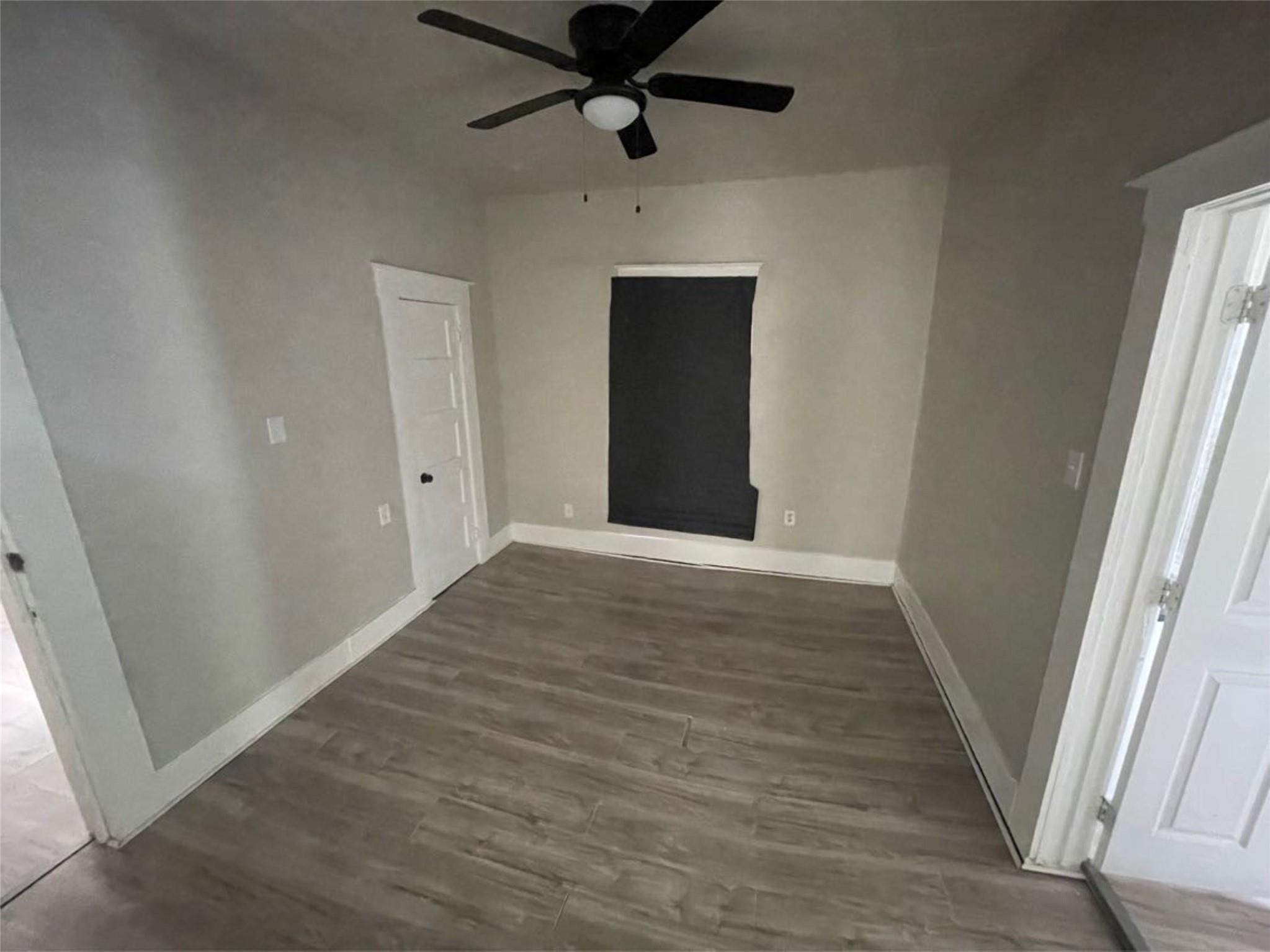 2010 13th Street Port Arthur, TX 77640 - Photo 16 of 22 en empty room with wooden floor and window