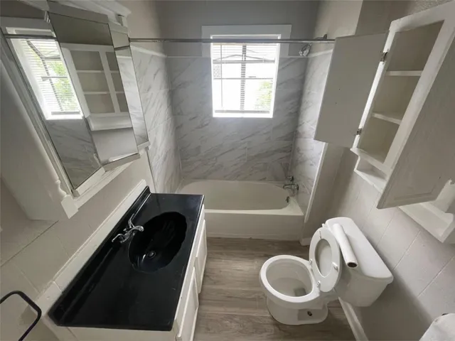 a bath tub sitting next to a toilet