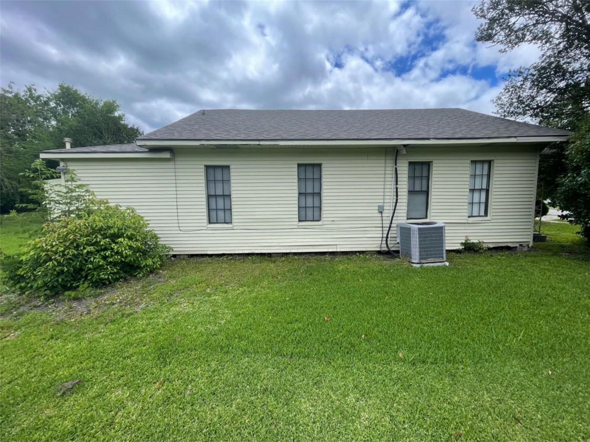 2010 13th Street Port Arthur, TX 77640 - Photo 5 of 22 a front view of a house with a garden and yard