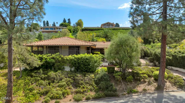 a front view of a house with a yard and fountain