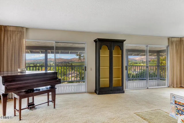 a view of an empty room with a balcony