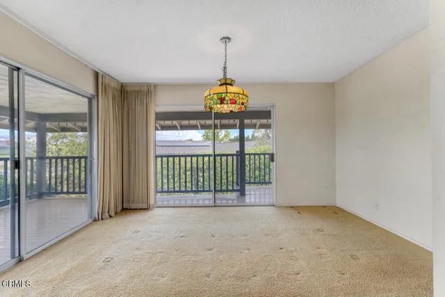 a view of an empty room with a fireplace and a window