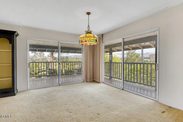 a view of a livingroom with an empty space and a fireplace