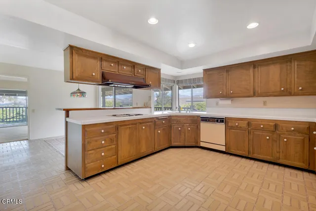 a kitchen with stainless steel appliances granite countertop a sink and cabinets