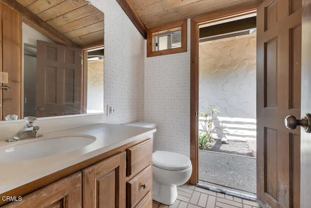 an aerial view of a house with a yard and trees