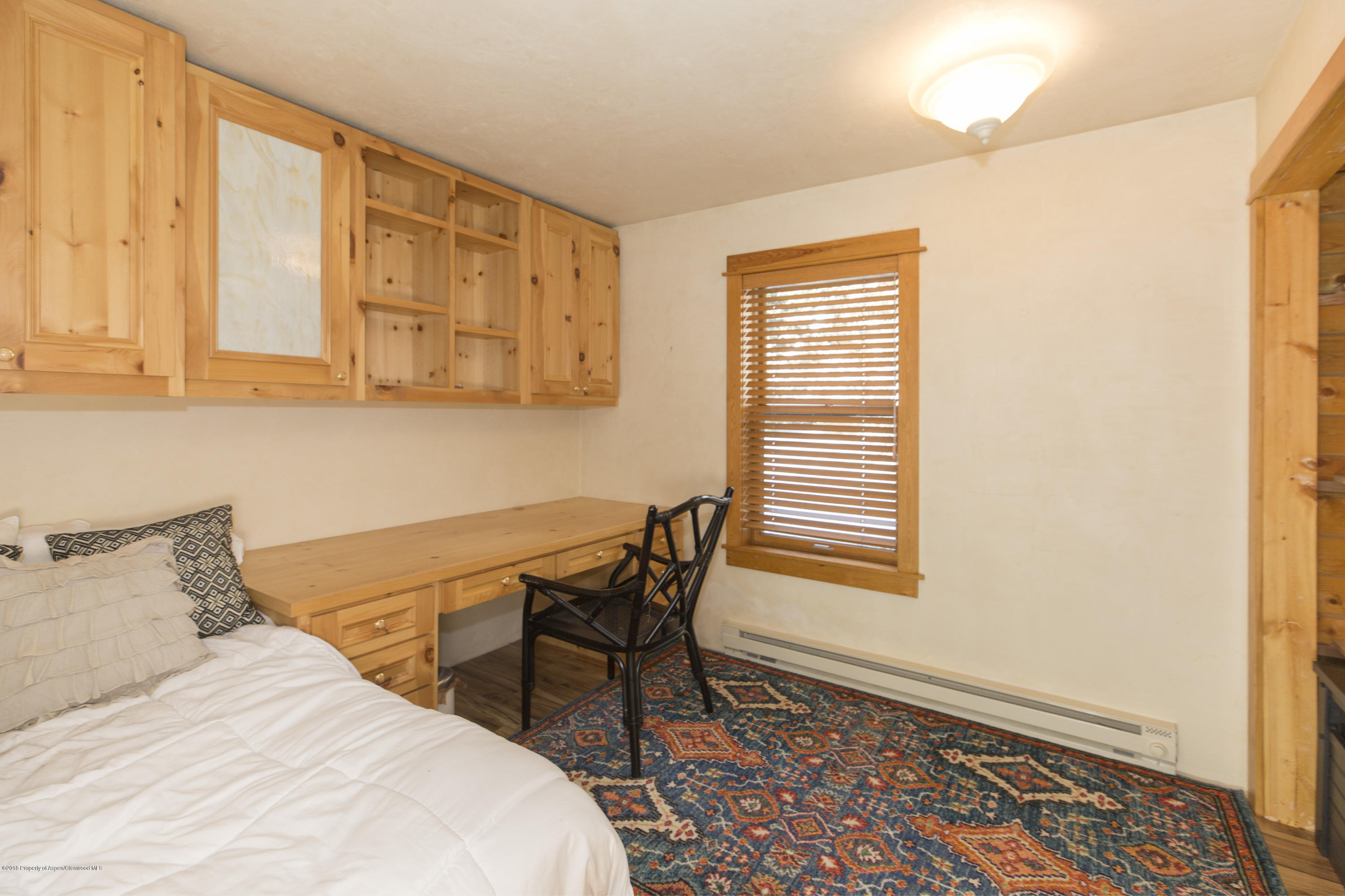 28 Holland Hills Road Basalt, CO 81621 - Photo 8 of 30 a bedroom with a chair and a window