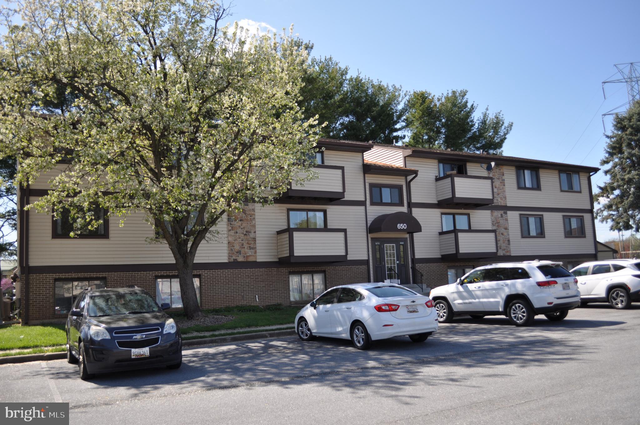 650 Heather Ridge Drive, Unit 12L Frederick, MD 21702 - Photo 20 of 20 a car parked in front of a white house