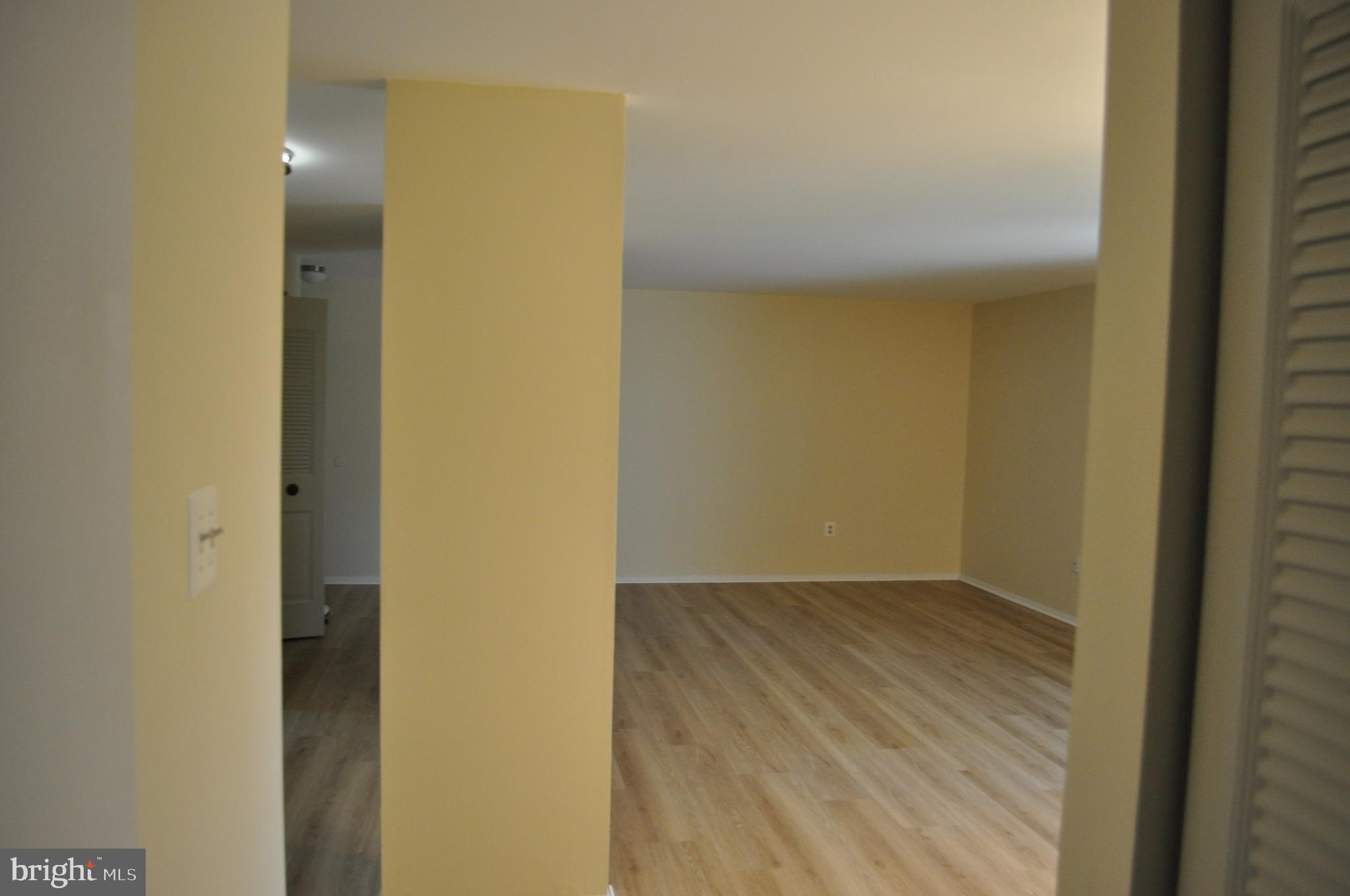 650 Heather Ridge Drive, Unit 12L Frederick, MD 21702 - Photo 3 of 20 an empty room with wooden floor