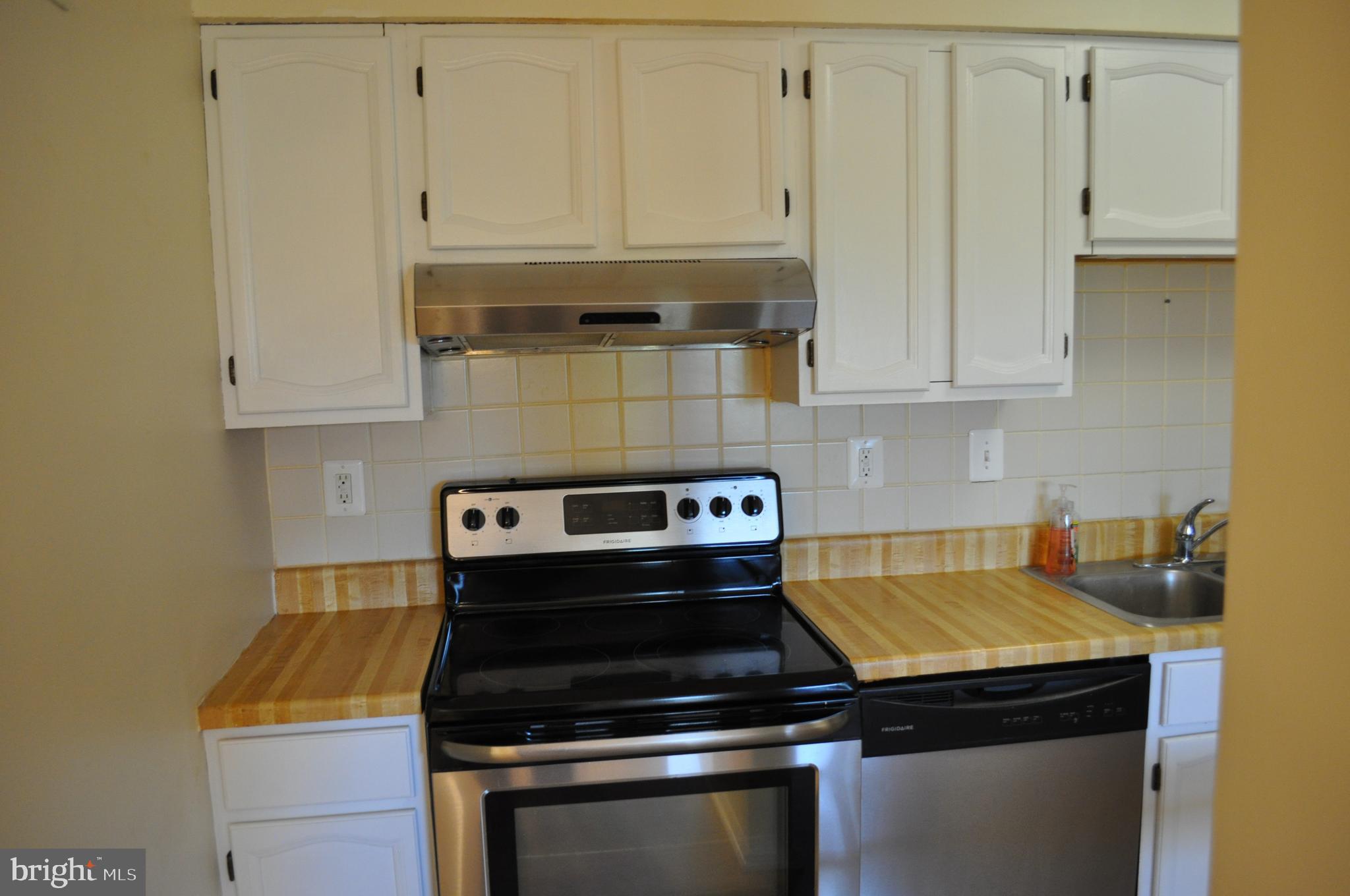 650 Heather Ridge Drive, Unit 12L Frederick, MD 21702 - Photo 6 of 20 a kitchen with a stove and white cabinets