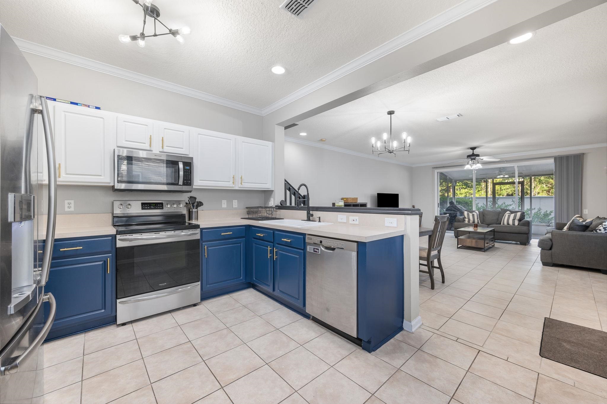 7990 Baymeadows Road East, Unit 1308 Jacksonville, FL 32256 - Photo 11 of 45 a kitchen with stainless steel appliances granite countertop a stove top oven a sink dishwasher and a refrigerator