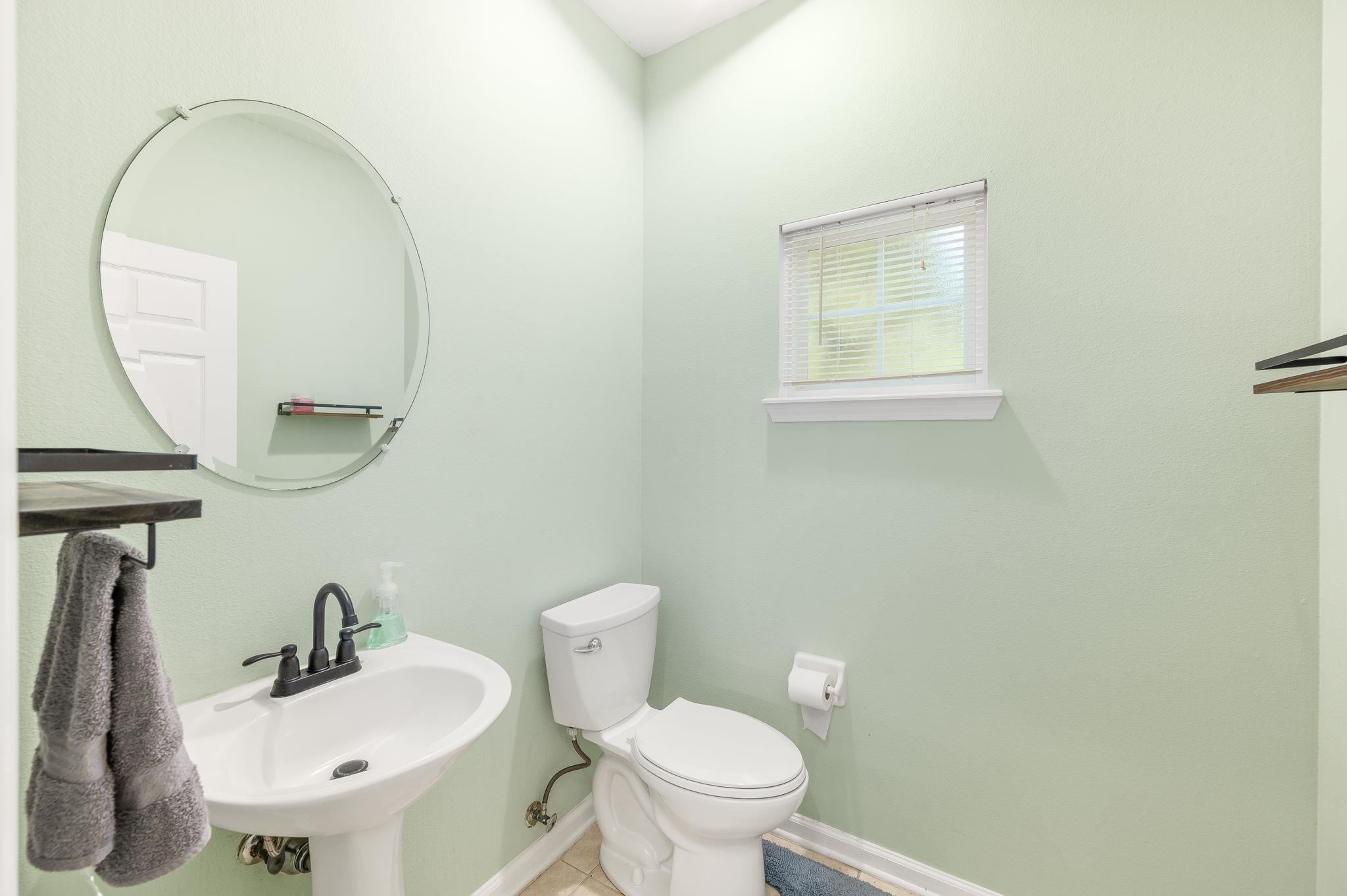 7990 Baymeadows Road East, Unit 1308 Jacksonville, FL 32256 - Photo 17 of 45 a bathroom with a toilet sink and mirror