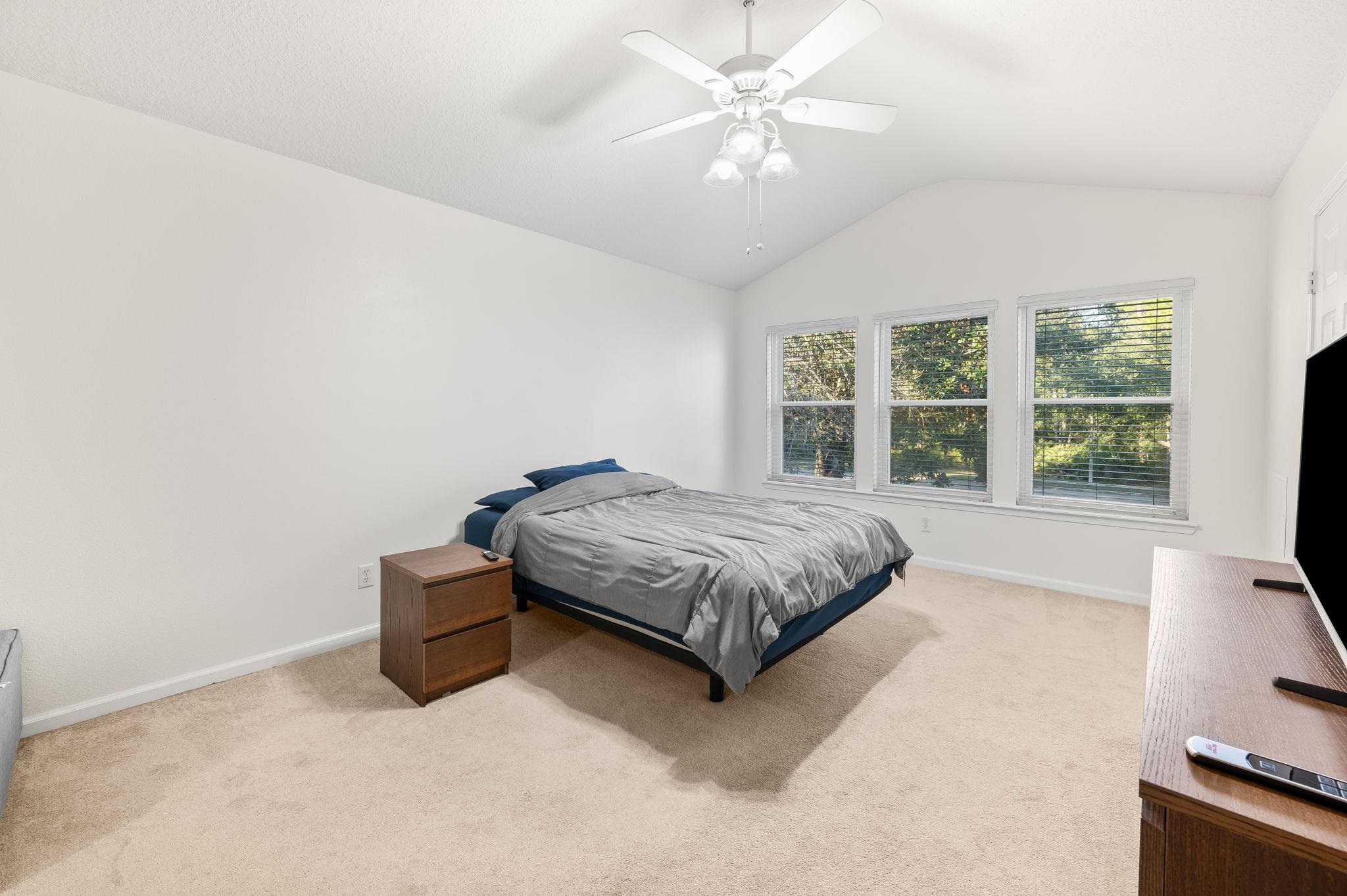 7990 Baymeadows Road East, Unit 1308 Jacksonville, FL 32256 - Photo 20 of 45 a bedroom with a bed window and a flat screen tv