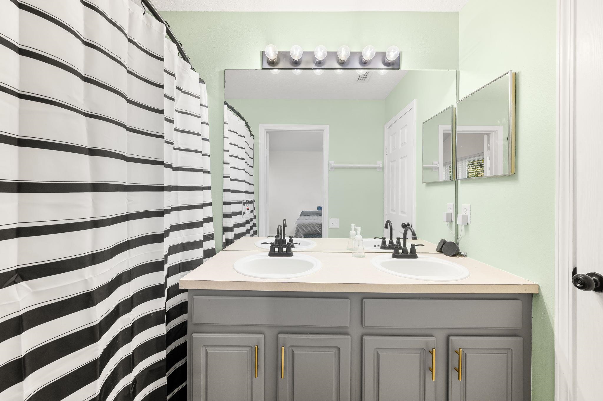 7990 Baymeadows Road East, Unit 1308 Jacksonville, FL 32256 - Photo 23 of 45 a bathroom with a sink and a mirror