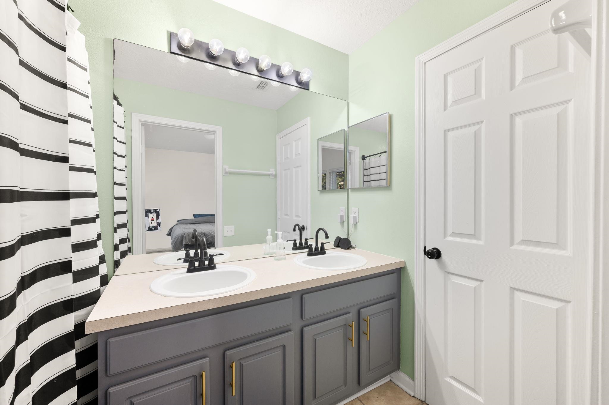 7990 Baymeadows Road East, Unit 1308 Jacksonville, FL 32256 - Photo 24 of 45 a bathroom with a sink and a mirror