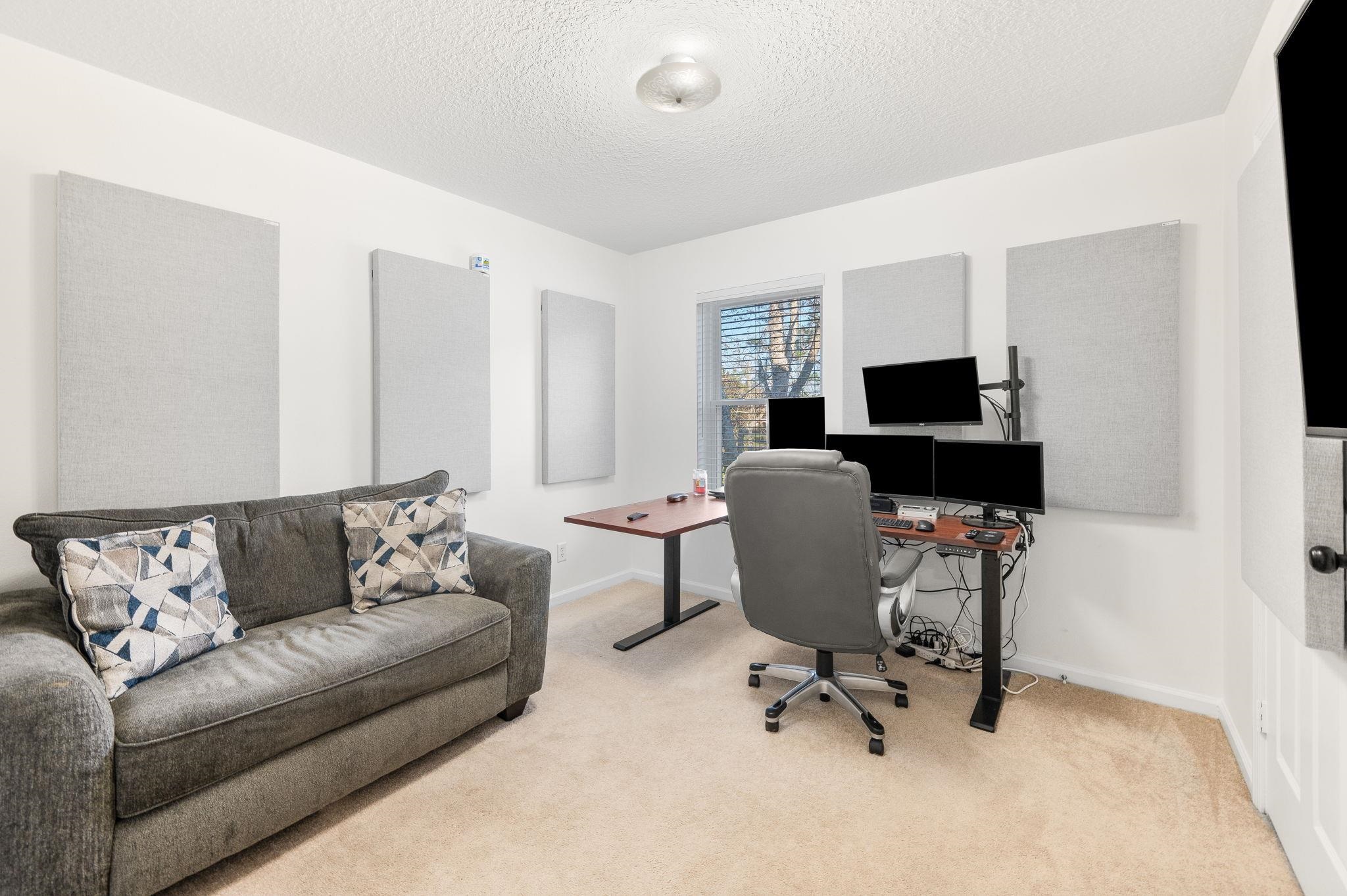 7990 Baymeadows Road East, Unit 1308 Jacksonville, FL 32256 - Photo 31 of 45 a living room with furniture and a flat screen tv