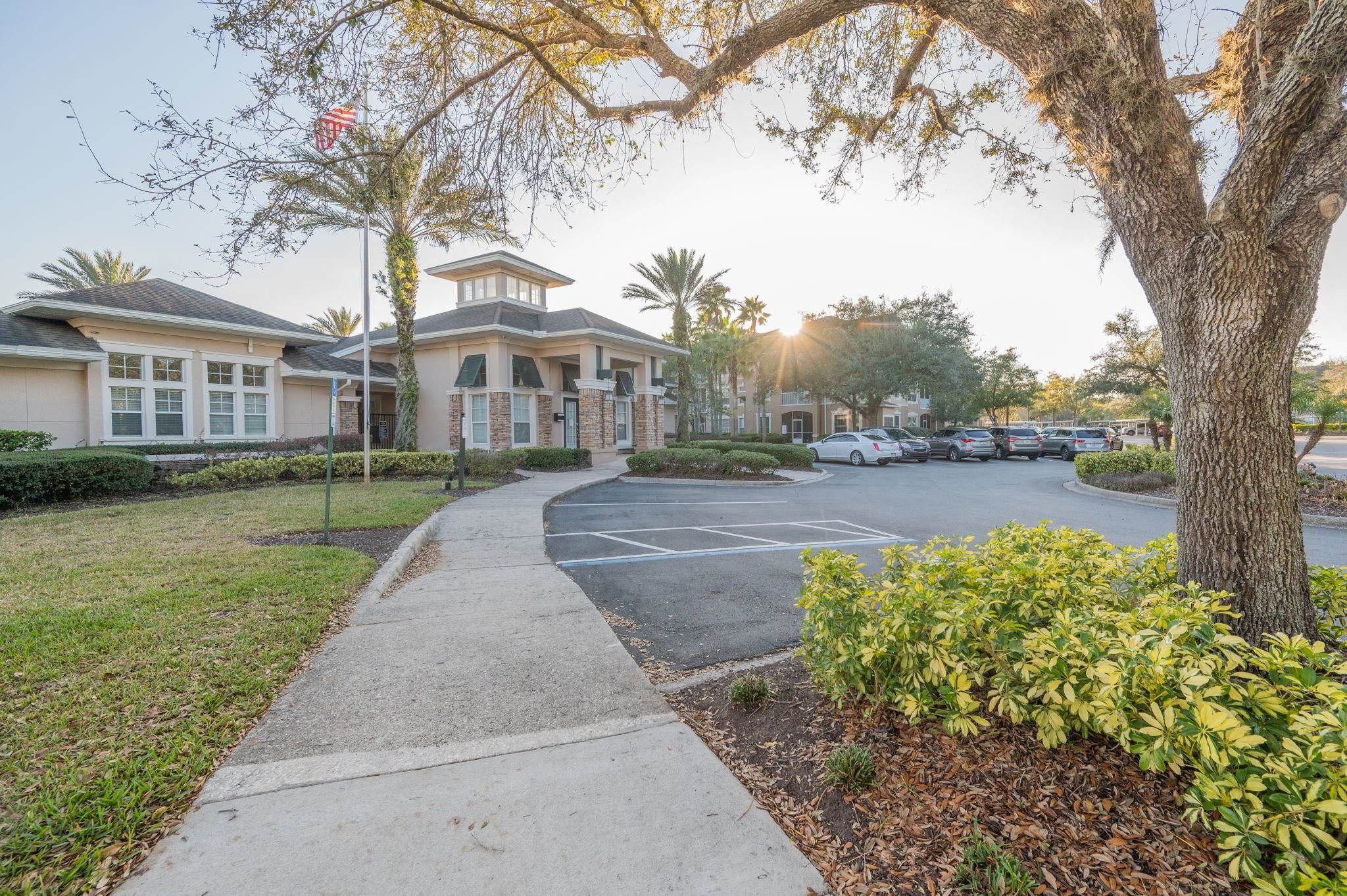 7990 Baymeadows Road East, Unit 1308 Jacksonville, FL 32256 - Photo 40 of 45 a front view of a house with a yard and large trees