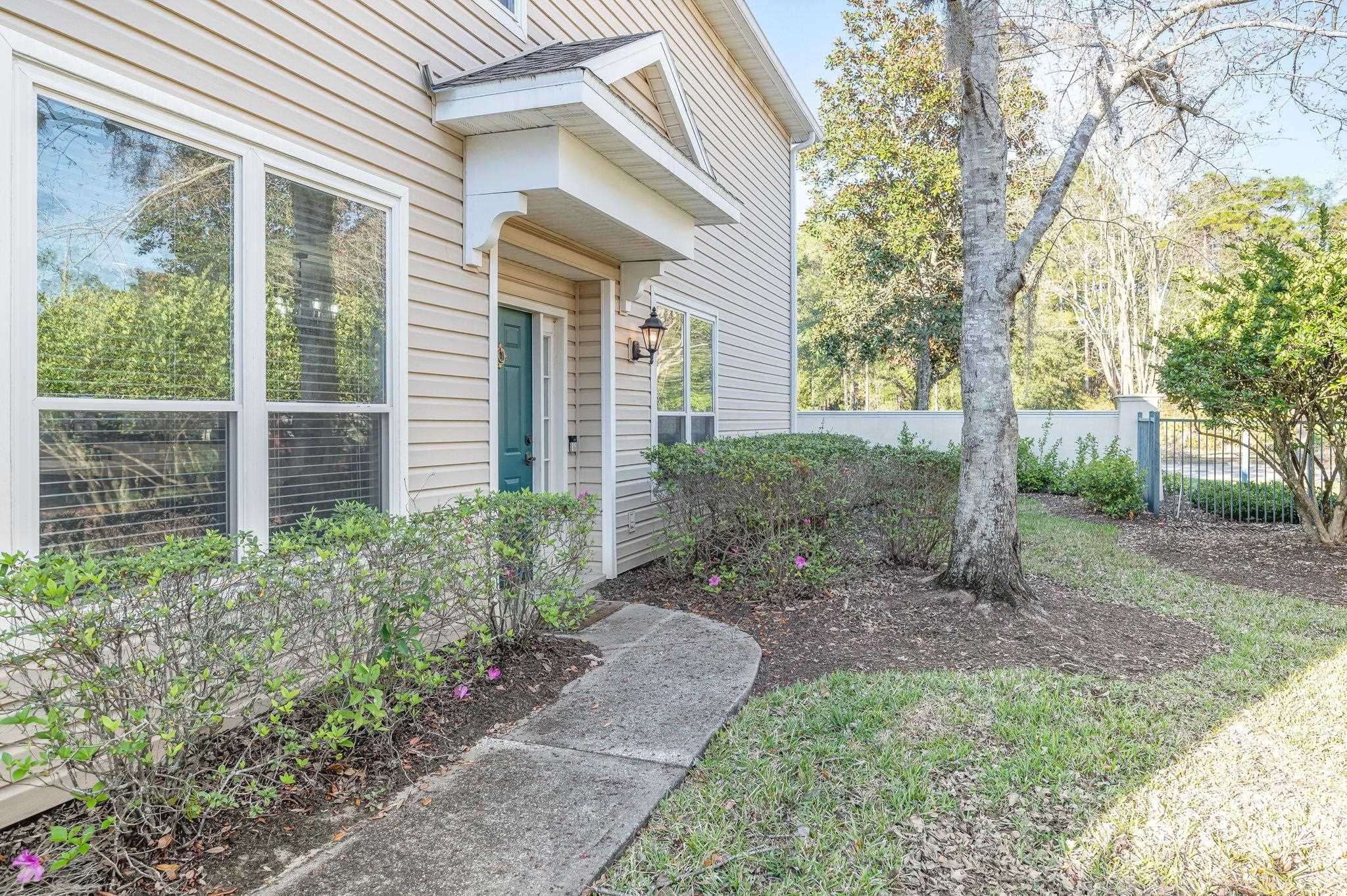 7990 Baymeadows Road East, Unit 1308 Jacksonville, FL 32256 - Photo 4 of 45 a view of a house with a yard and plants