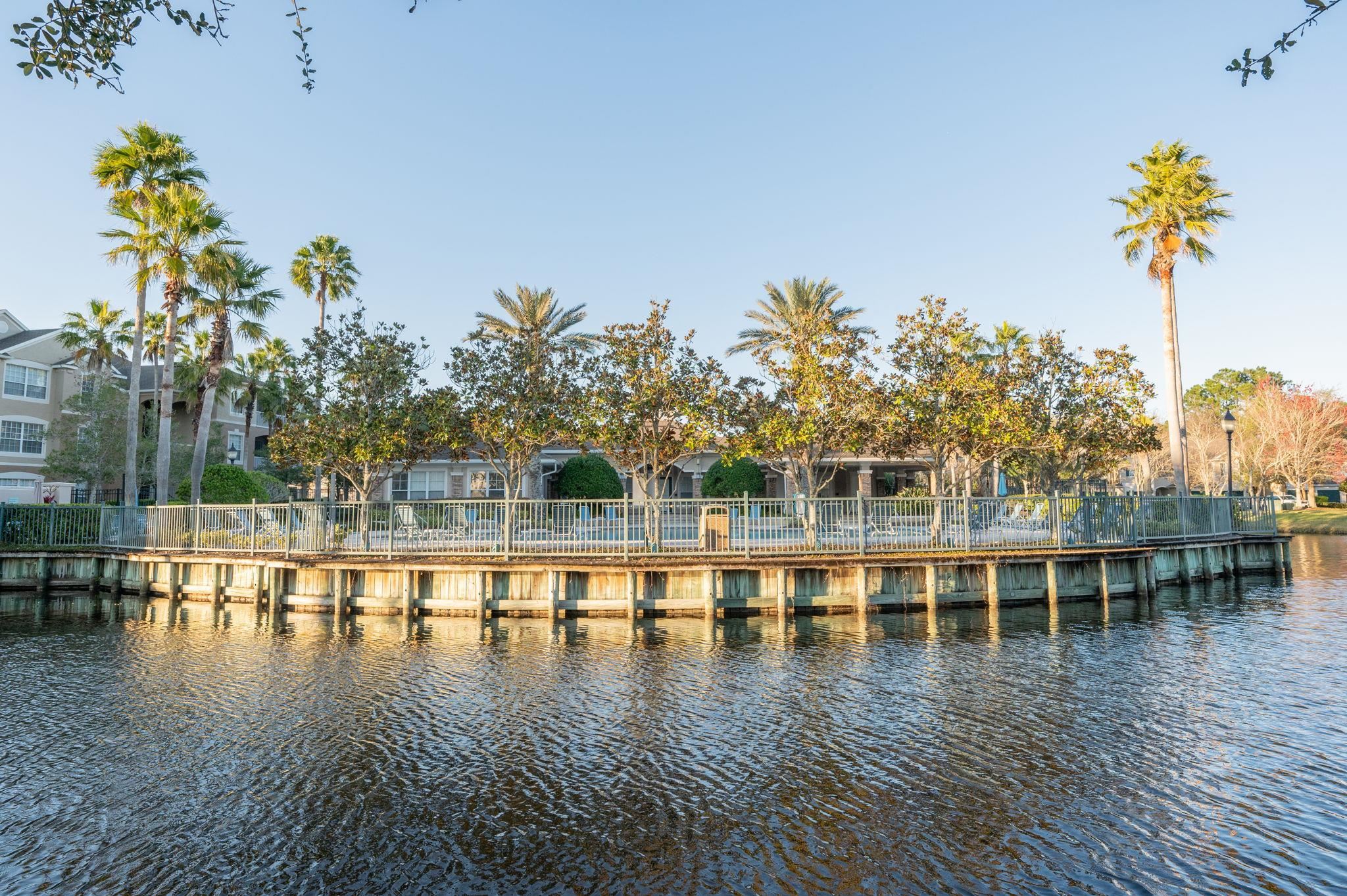 7990 Baymeadows Road East, Unit 1308 Jacksonville, FL 32256 - Photo 43 of 45 a view of a swimming pool with a table and chairs