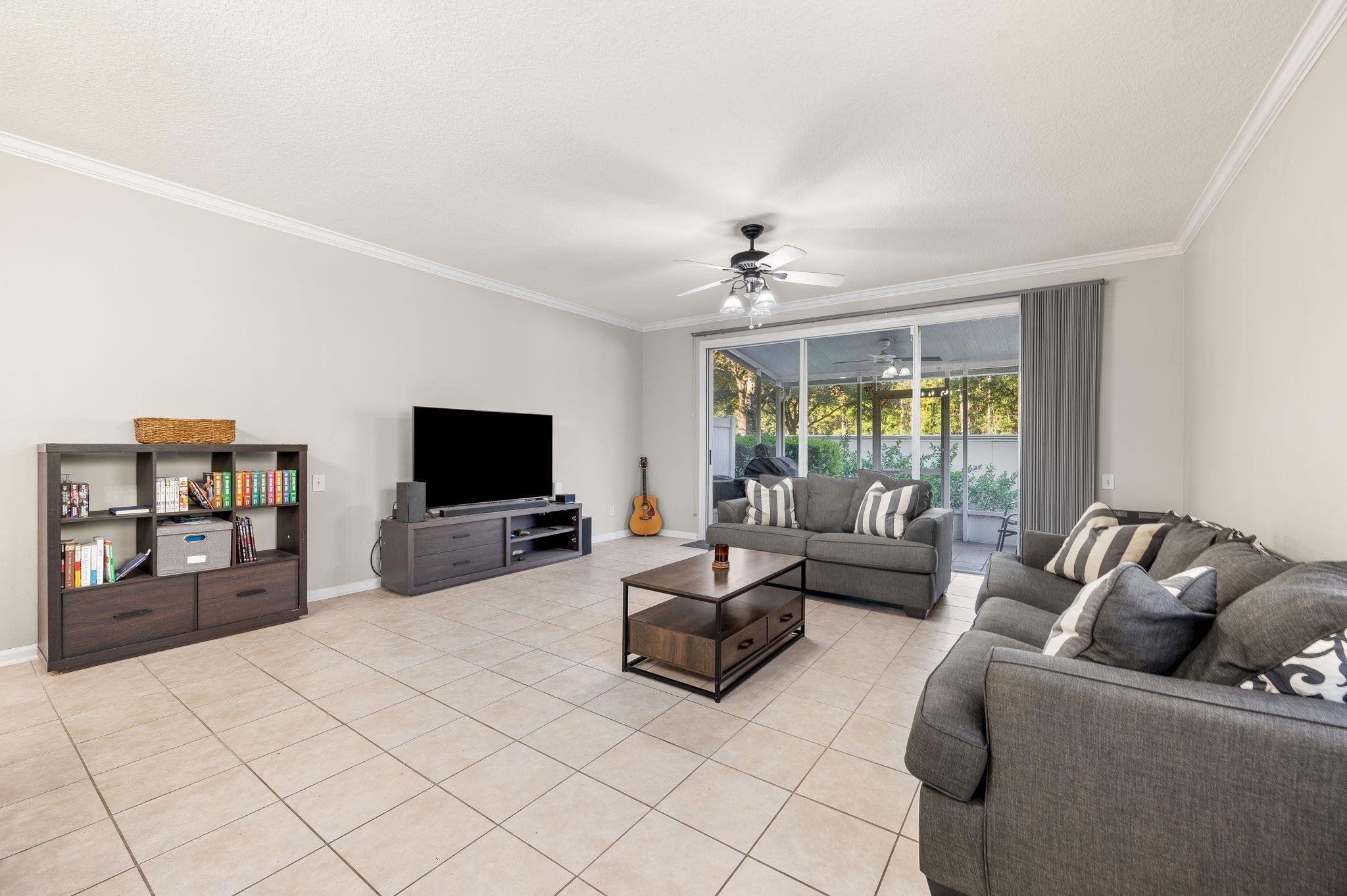 7990 Baymeadows Road East, Unit 1308 Jacksonville, FL 32256 - Photo 5 of 45 a living room with furniture and a flat screen tv
