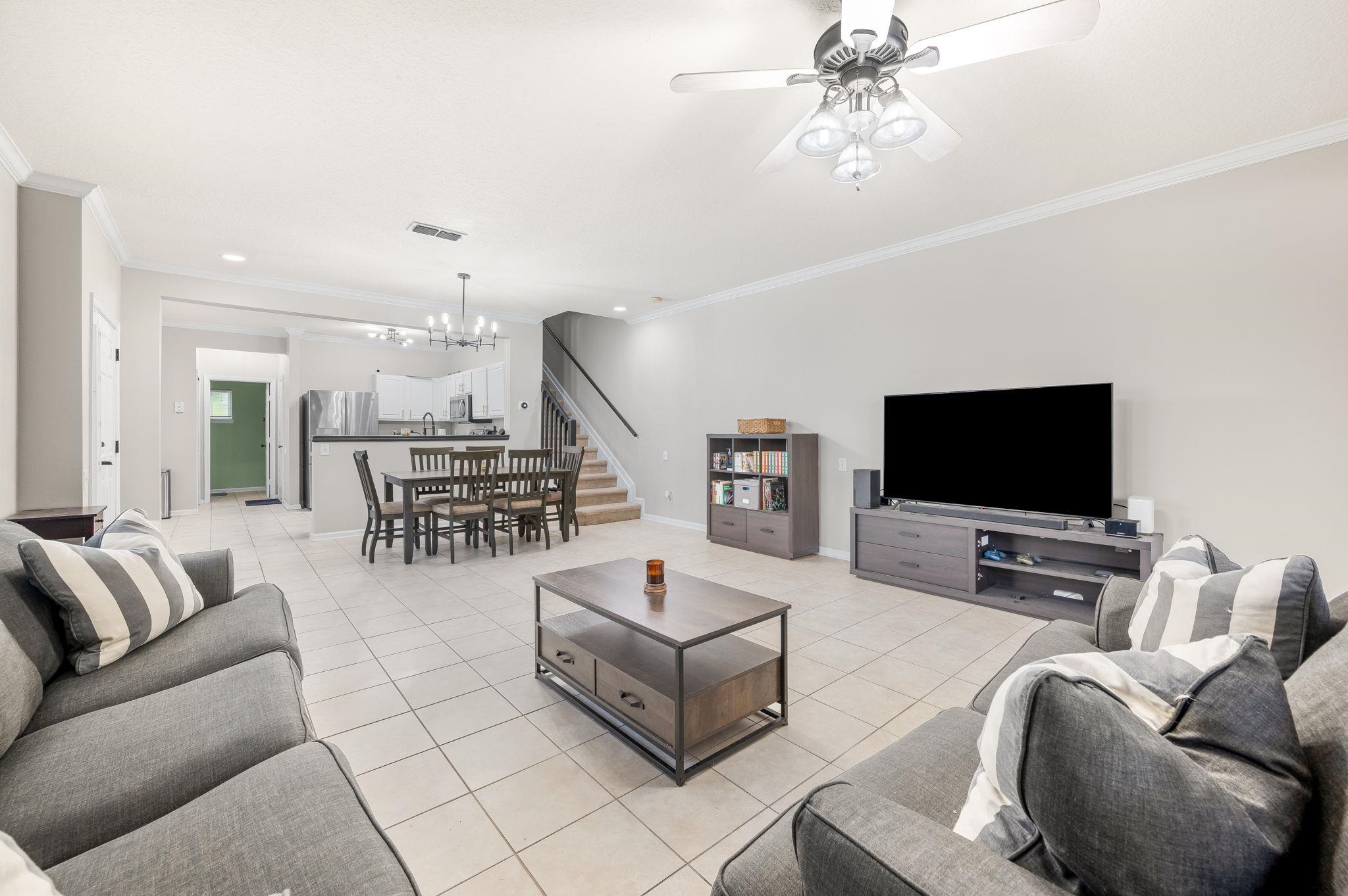 7990 Baymeadows Road East, Unit 1308 Jacksonville, FL 32256 - Photo 7 of 45 a living room with furniture and a flat screen tv