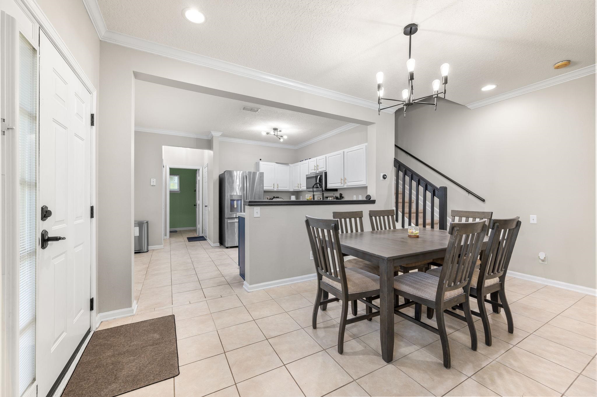 7990 Baymeadows Road East, Unit 1308 Jacksonville, FL 32256 - Photo 9 of 45 a view of a dining room with furniture