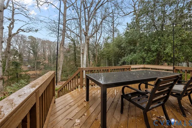 a view of a roof deck with wooden fence and floor