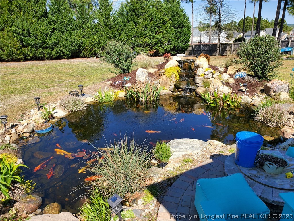 563 Sawyer Road Cameron, NC 28326 - Photo 11 of 43 a view of a lake with outside dining space