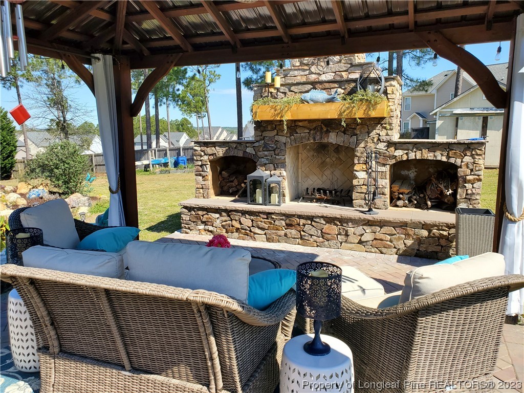 563 Sawyer Road Cameron, NC 28326 - Photo 13 of 43 a outdoor living space with furniture and a fireplace