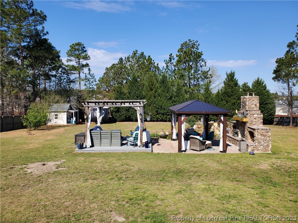 563 Sawyer Road Cameron, NC 28326 - Photo 17 of 43 a view of a park with lawn chairs under an umbrella