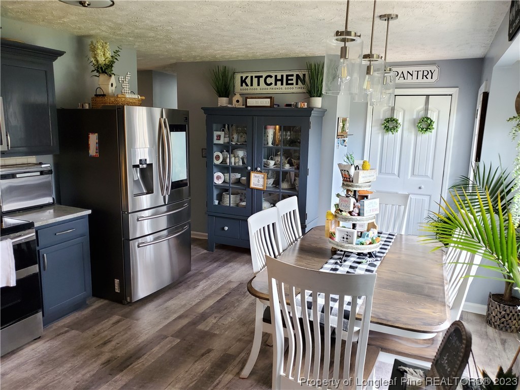 563 Sawyer Road Cameron, NC 28326 - Photo 22 of 43 a view of a dining room with furniture window and wooden floor