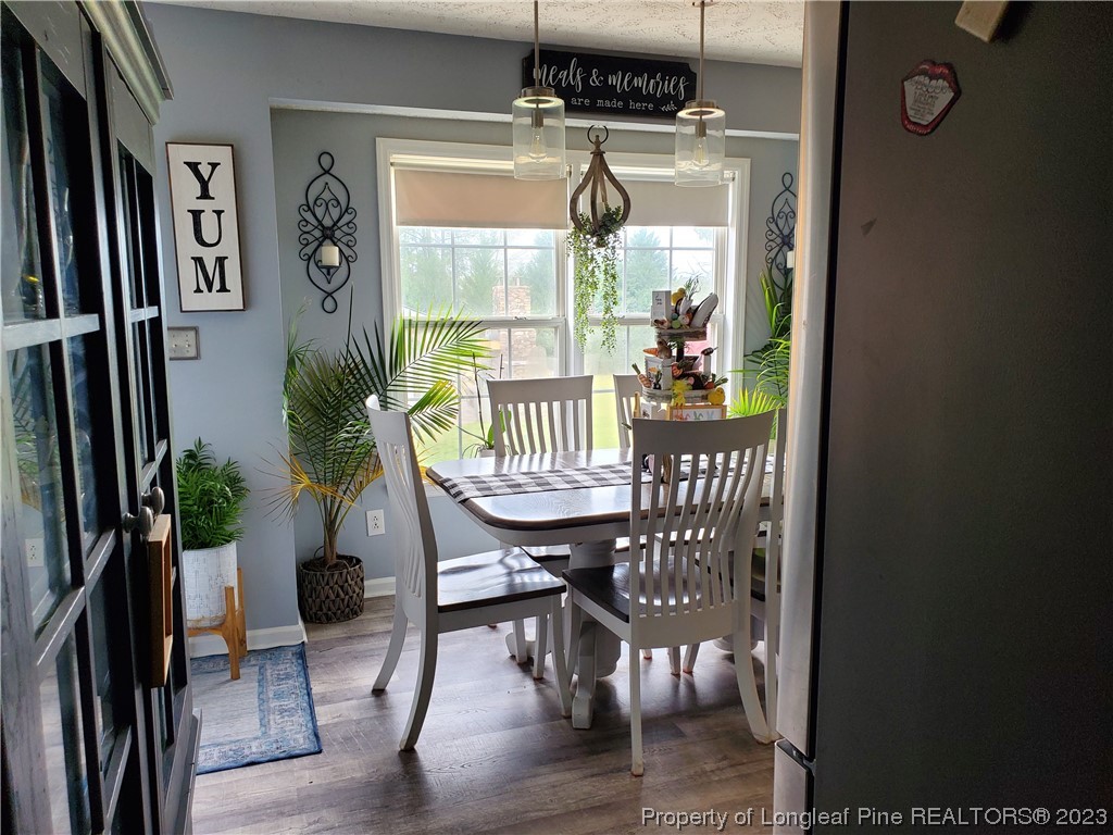 563 Sawyer Road Cameron, NC 28326 - Photo 25 of 43 a view of a dining room with furniture window and wooden floor