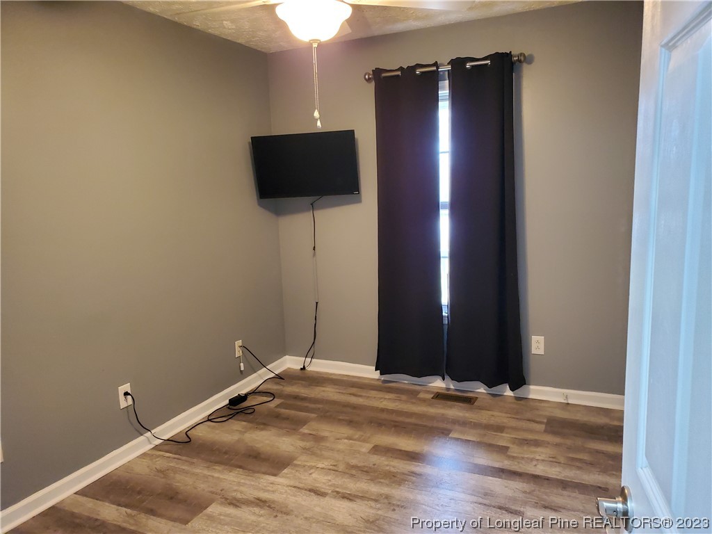 563 Sawyer Road Cameron, NC 28326 - Photo 28 of 43 a view of a livingroom with wooden floor and a flat screen tv