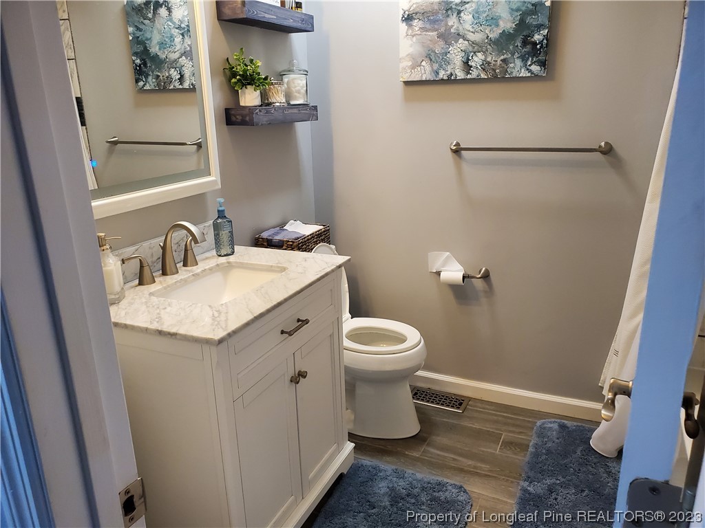 563 Sawyer Road Cameron, NC 28326 - Photo 36 of 43 a bathroom with a toilet sink and mirror