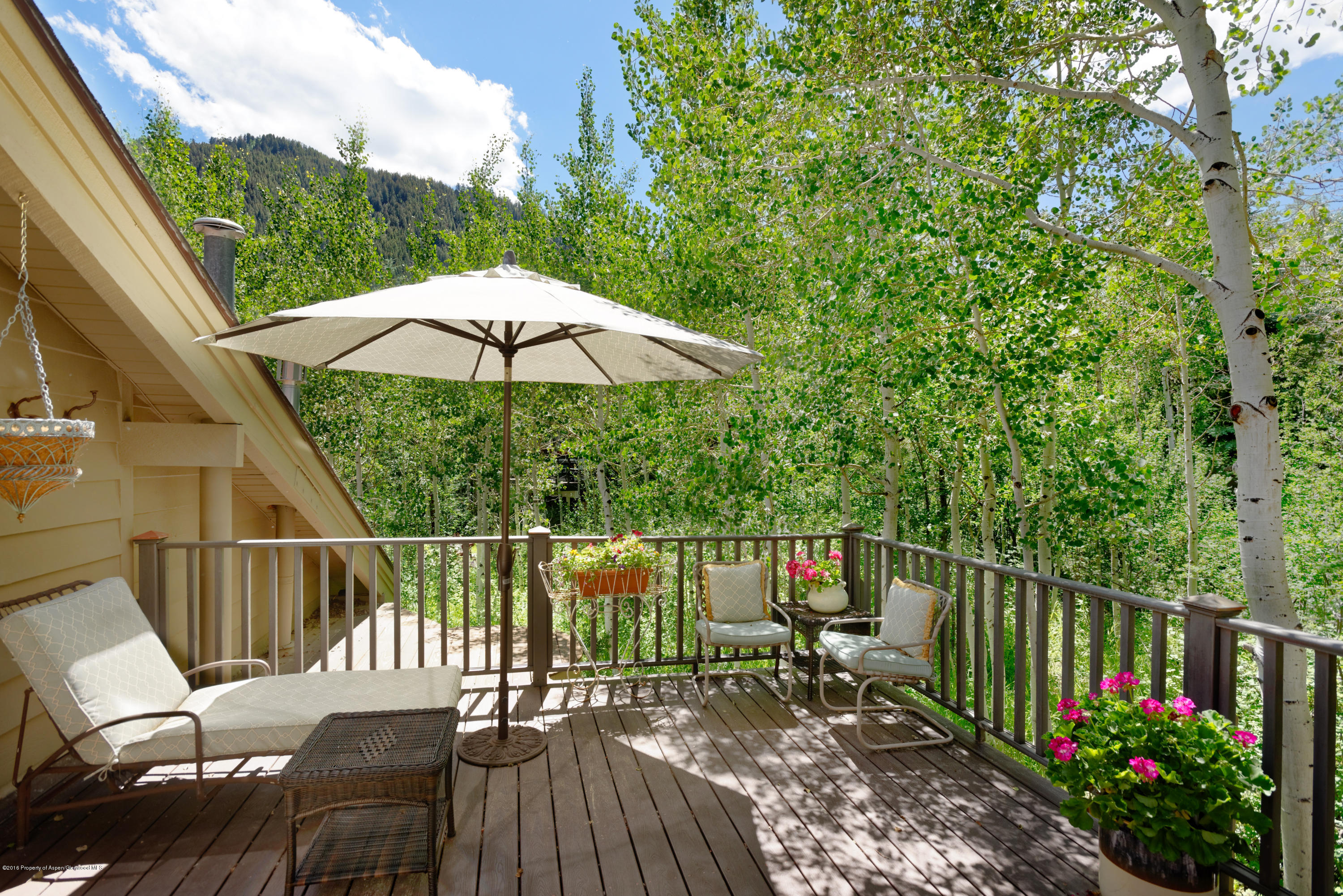 1300 Riverside Drive Aspen, CO 81611 - Photo 12 of 24 a view of a balcony with wooden floor and umbrella