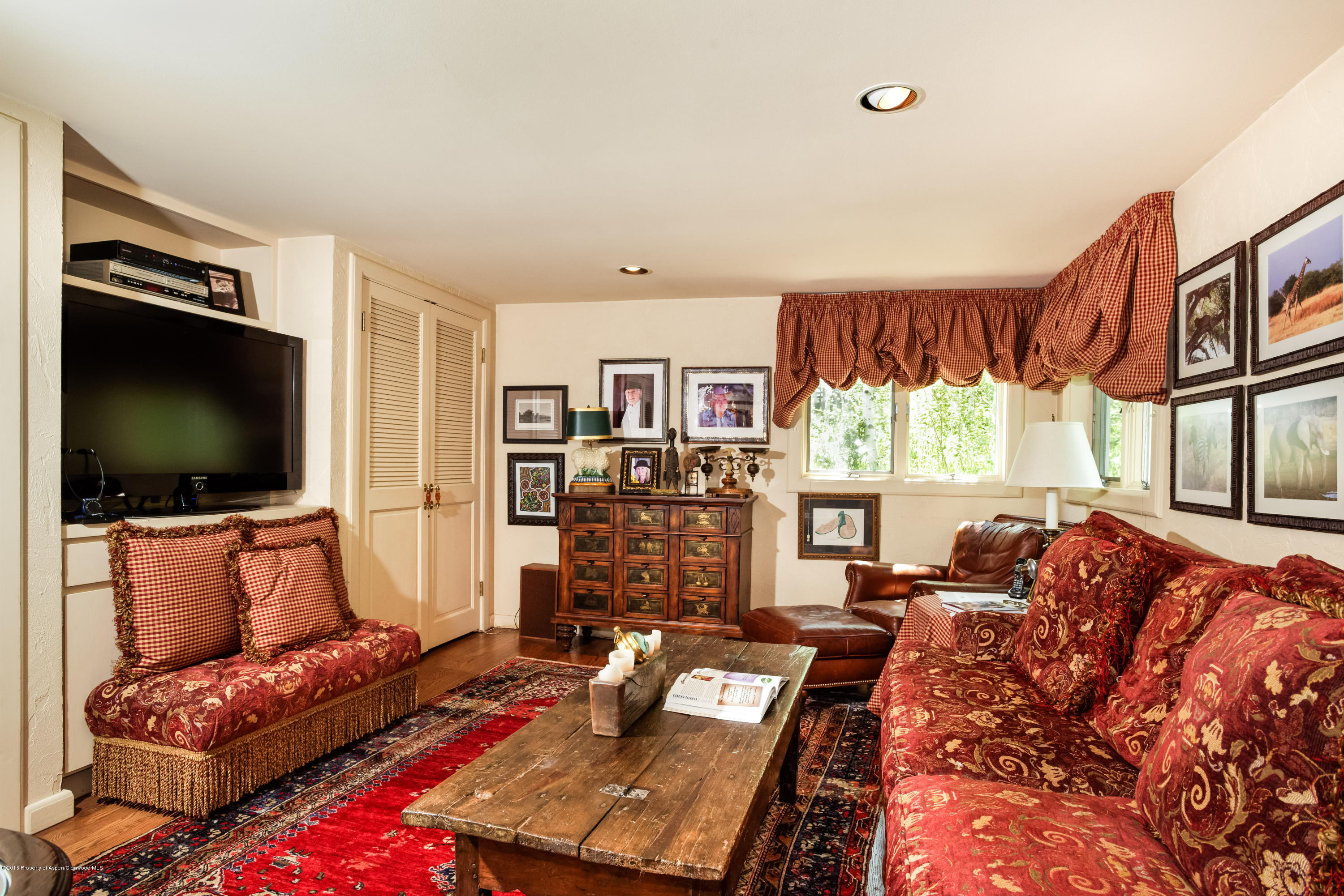 1300 Riverside Drive Aspen, CO 81611 - Photo 17 of 24 a living room with furniture and a flat screen tv